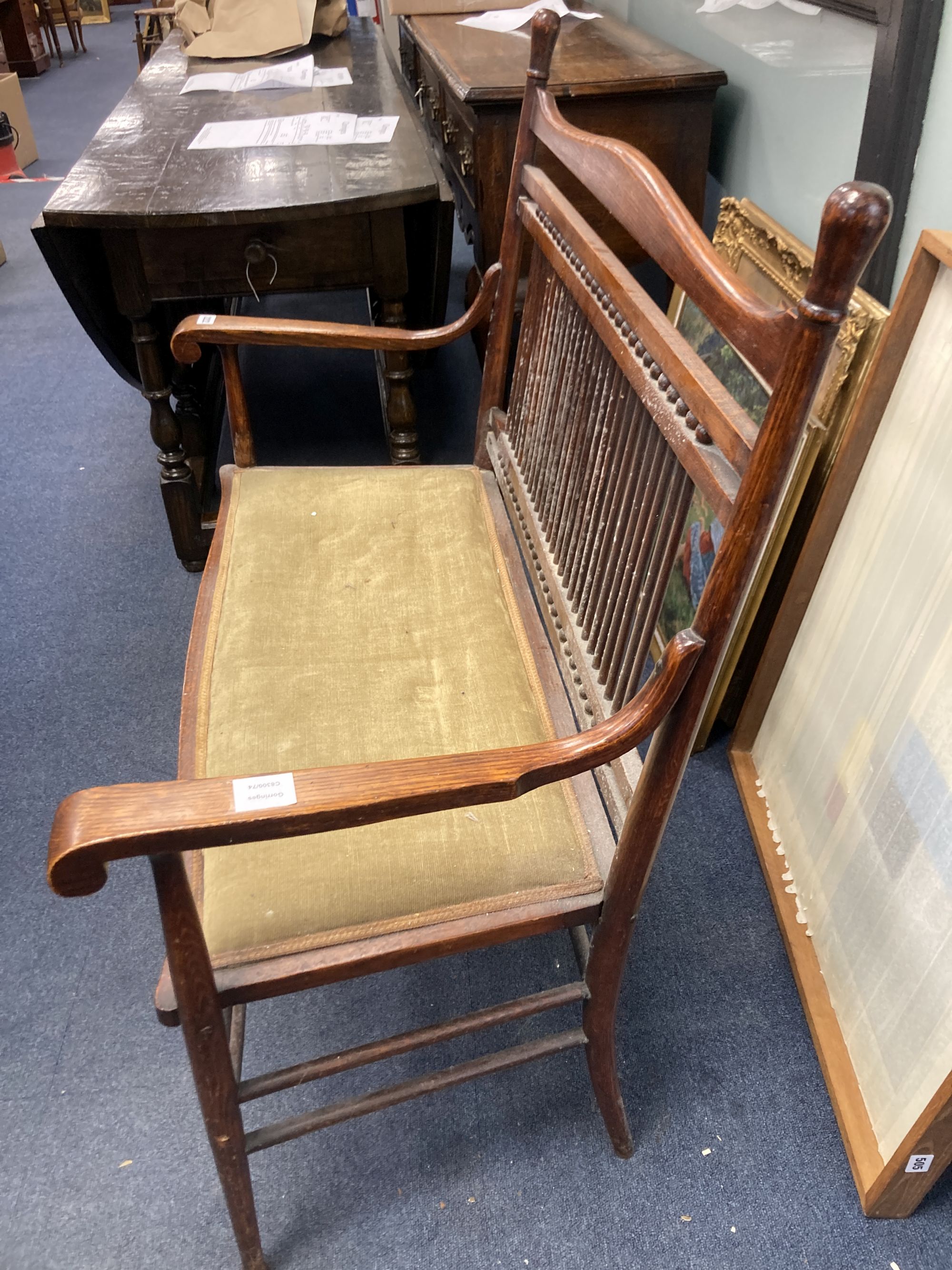 An early 20th century oak two seater chair back settee, width 100cm, depth 50cm, height 99cm